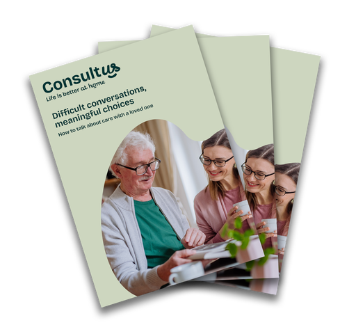 A live-in carere sitting with aapatient discussing some paperwork