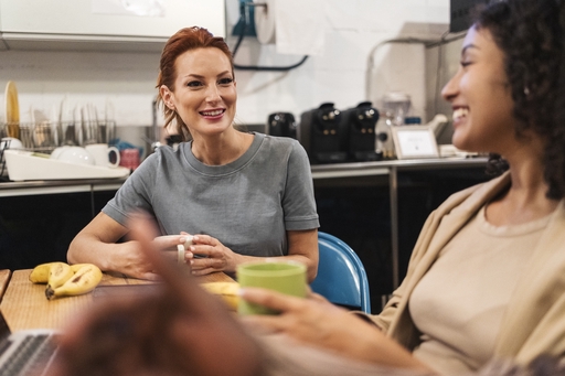 A live-in carer and a lady sitting at a table.