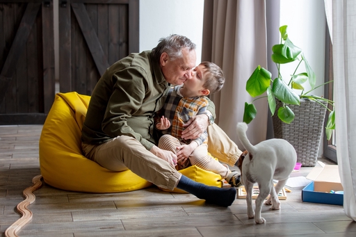 A man sitting in a bean bag enjoying some tine with his grandson.