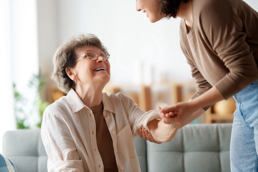 A man shaking an elderly women's hand