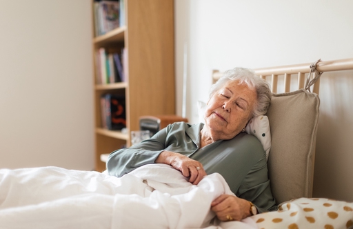 Old lady Enjoying cake with carer