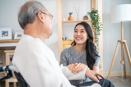 A live-in nurse chatting with a patient.