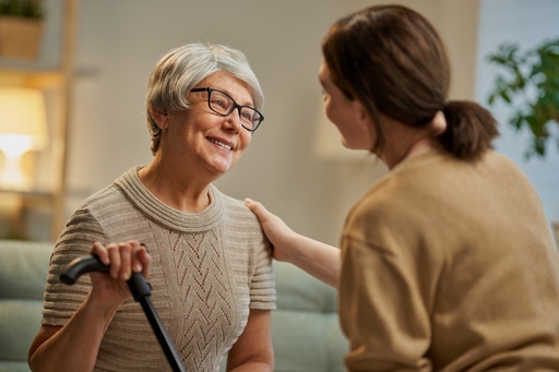 An elderly lady being reassured by a live-in carer.